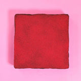 Raspberry & Dark Chocolate Brownie by Crumbs & Doilies with raspberry powder topping on a pink background